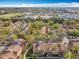 A high-angle shot of a condo community, showcasing buildings, landscaping, parking, and nearby commercial developments at 832 Grand Regency Pt # 102, Altamonte Springs, FL 32714