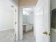 Hallway shot of bathroom featuring a neutral-toned vanity and a toilet, complemented by light tile flooring at 832 Grand Regency Pt # 102, Altamonte Springs, FL 32714