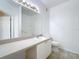 Well-lit bathroom featuring a large mirror, vanity with storage, and a convenient toilet at 832 Grand Regency Pt # 102, Altamonte Springs, FL 32714