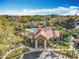 Aerial view of the clubhouse featuring manicured landscaping with tall palm trees and nearby pool at 832 Grand Regency Pt # 102, Altamonte Springs, FL 32714