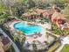 Aerial view of community pool surrounded by lounge chairs, palm trees, and lush landscaping at 832 Grand Regency Pt # 102, Altamonte Springs, FL 32714