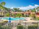 Relaxing community pool with lounge chairs and umbrella-covered tables surrounded by lush, tropical landscaping at 832 Grand Regency Pt # 102, Altamonte Springs, FL 32714