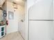 Functional laundry room with washer, dryer, water heater, and shelving for organized storage at 832 Grand Regency Pt # 102, Altamonte Springs, FL 32714