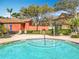 Community pool featuring a tiered step entry, nearby tables and chairs, and surrounding landscape at 832 Grand Regency Pt # 102, Altamonte Springs, FL 32714