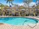 Community pool with clear water, lounge chairs, and a view of the townhomes at 832 Grand Regency Pt # 102, Altamonte Springs, FL 32714