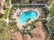 Aerial view of a community pool featuring lounge chairs, landscaping, and well maintained grounds at 832 Grand Regency Pt # 102, Altamonte Springs, FL 32714