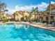 Large community pool with lounge chairs and a view of the surrounding townhomes at 832 Grand Regency Pt # 102, Altamonte Springs, FL 32714