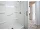 Clean shower with safety bar, adjustable shower head, and built-in shelving and an entrance to the bathroom at 832 Grand Regency Pt # 102, Altamonte Springs, FL 32714