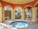 Covered outdoor spa with red columns, archways and tile flooring at 832 Grand Regency Pt # 102, Altamonte Springs, FL 32714