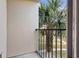 Private balcony overlooking palm trees and lawn at 8757 Via Tavoleria Way, Windermere, FL 34786