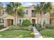 Two-story townhome with attractive landscaping and a welcoming front porch at 8757 Via Tavoleria Way, Windermere, FL 34786