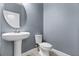 Clean powder room with pedestal sink and toilet at 8757 Via Tavoleria Way, Windermere, FL 34786