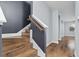 Modern staircase with wood steps and dark gray wall at 8757 Via Tavoleria Way, Windermere, FL 34786