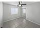 Well-lit bedroom with tile flooring and mirrored closet doors at 8813 Parliament Ct, Kissimmee, FL 34747