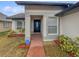 Inviting entryway with a brick walkway leading to a black front door at 8813 Parliament Ct, Kissimmee, FL 34747