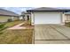 House exterior showcasing a two-car garage and well-maintained lawn at 8813 Parliament Ct, Kissimmee, FL 34747