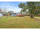 Backyard view showing home, deck, and large tree at 922 Wyoming Ave, St Cloud, FL 34769