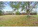 Spacious backyard with grassy area and wooden fence at 922 Wyoming Ave, St Cloud, FL 34769