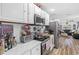 Bright kitchen with white cabinets, stainless steel appliances and a view to living room at 922 Wyoming Ave, St Cloud, FL 34769