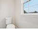 Small bathroom with a toilet and a window at 9457 Randal Park Blvd, Orlando, FL 32832