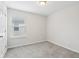 Simple bedroom with grey carpet, window, and a door at 9457 Randal Park Blvd, Orlando, FL 32832