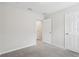 Spacious bedroom with carpet, doors, and access to a bathroom at 9457 Randal Park Blvd, Orlando, FL 32832