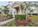 Landscaped entrance to a two-story townhome with covered porch at 9457 Randal Park Blvd, Orlando, FL 32832