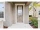 Modern front door with glass panel and neutral color scheme at 9457 Randal Park Blvd, Orlando, FL 32832