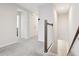 Upstairs hallway with carpeted floor and doors to bedrooms at 9457 Randal Park Blvd, Orlando, FL 32832