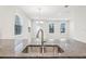 Double sink with modern faucet in granite countertop at 9457 Randal Park Blvd, Orlando, FL 32832