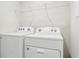 Laundry room with Whirlpool washer and dryer, and shelving at 9457 Randal Park Blvd, Orlando, FL 32832