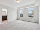 Main bedroom with carpet, two windows, and a view of the outdoors at 9457 Randal Park Blvd, Orlando, FL 32832