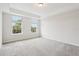 Main bedroom with carpet, two windows, and a view of the outdoors at 9457 Randal Park Blvd, Orlando, FL 32832