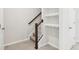 Stairwell with built-in shelving and wooden handrail at 9457 Randal Park Blvd, Orlando, FL 32832