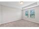 Well-lit bedroom with neutral-toned carpet and two windows at 9693 Lost Creek Dr, Winter Garden, FL 34787