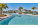 Inviting community pool with palm trees and lounge chairs at 9693 Lost Creek Dr, Winter Garden, FL 34787