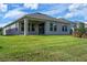 House with covered patio and grassy backyard at 9693 Lost Creek Dr, Winter Garden, FL 34787