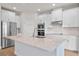 Modern kitchen featuring white cabinets, quartz countertops, and stainless steel appliances at 9693 Lost Creek Dr, Winter Garden, FL 34787