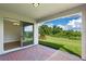 Covered patio with brick pavers, sliding glass doors, and view of grassy backyard at 9693 Lost Creek Dr, Winter Garden, FL 34787