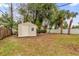 Tan shed in backyard with green lawn at 107 Japonica Dr, Orlando, FL 32807