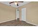Bedroom with wood-look floors, ceiling fan and double door closet at 107 Japonica Dr, Orlando, FL 32807