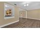 Bright dining room features wood-look floors and a view into the kitchen at 107 Japonica Dr, Orlando, FL 32807