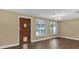 Dining room with wood-look floors, access door, and pool view at 107 Japonica Dr, Orlando, FL 32807