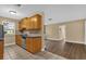 Kitchen with wood cabinets, granite counters, and stainless steel appliances at 107 Japonica Dr, Orlando, FL 32807