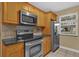 Kitchen with wood cabinets, granite countertops, and stainless steel appliances at 107 Japonica Dr, Orlando, FL 32807