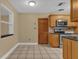 Kitchen with wood cabinets, granite counters, and stainless steel appliances at 107 Japonica Dr, Orlando, FL 32807