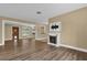 Open living room with wood-look floors and a view into another room at 107 Japonica Dr, Orlando, FL 32807