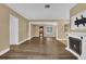 Open living room with wood-look floors and a view into another room at 107 Japonica Dr, Orlando, FL 32807