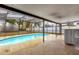 Screened pool area with concrete decking and wet bar at 107 Japonica Dr, Orlando, FL 32807