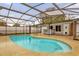 Screened pool and patio area with adjacent house at 107 Japonica Dr, Orlando, FL 32807